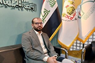 اهدای پرچم حرم حسینی در نمایشگاه قرآن + عکس